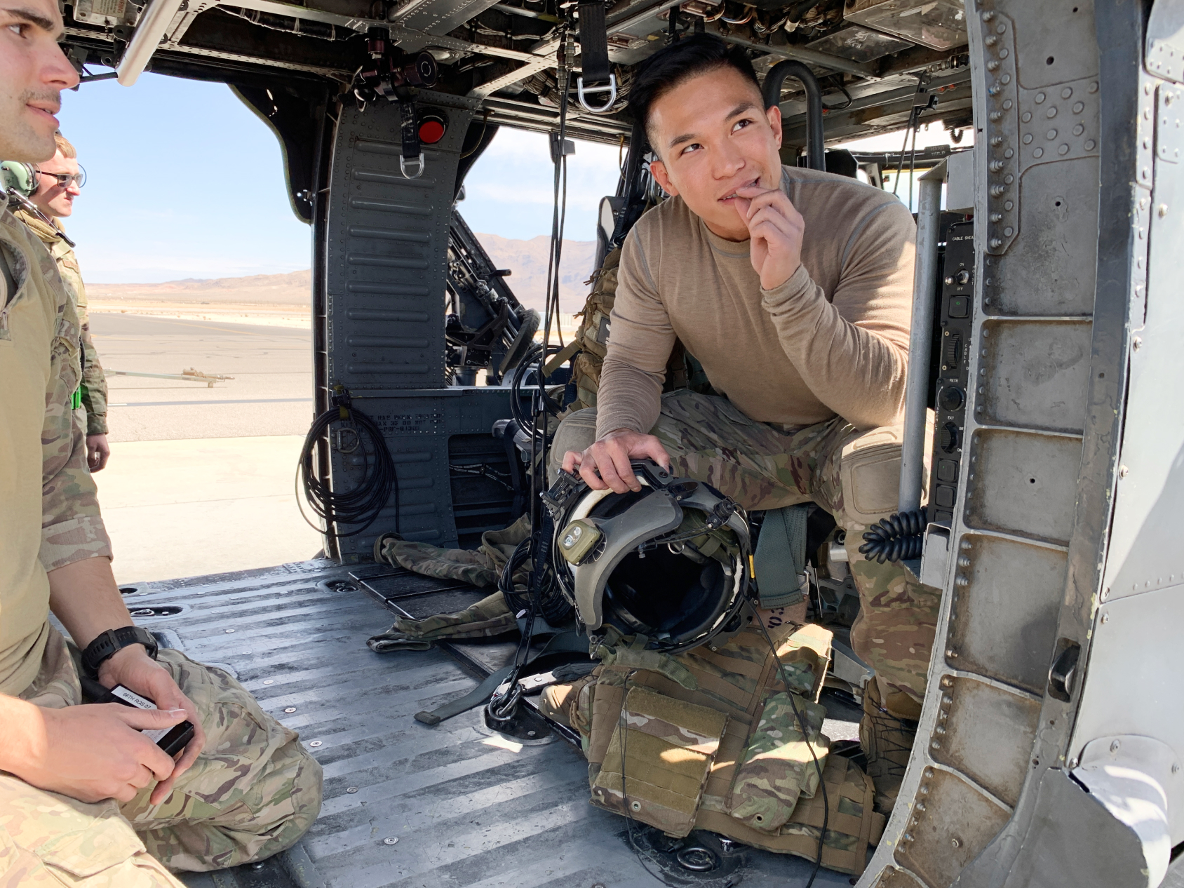 Two airmen sitting inside an aircraft